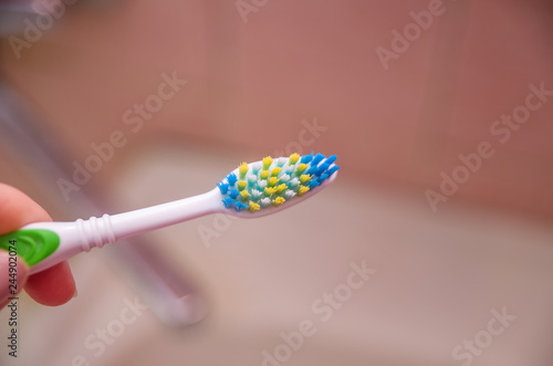 Tooth brush close-up over the sink without toothpaste