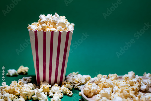 Popcorn in a box spread on a colored background