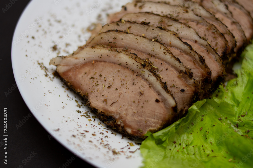 meat on a white plate with lettuce