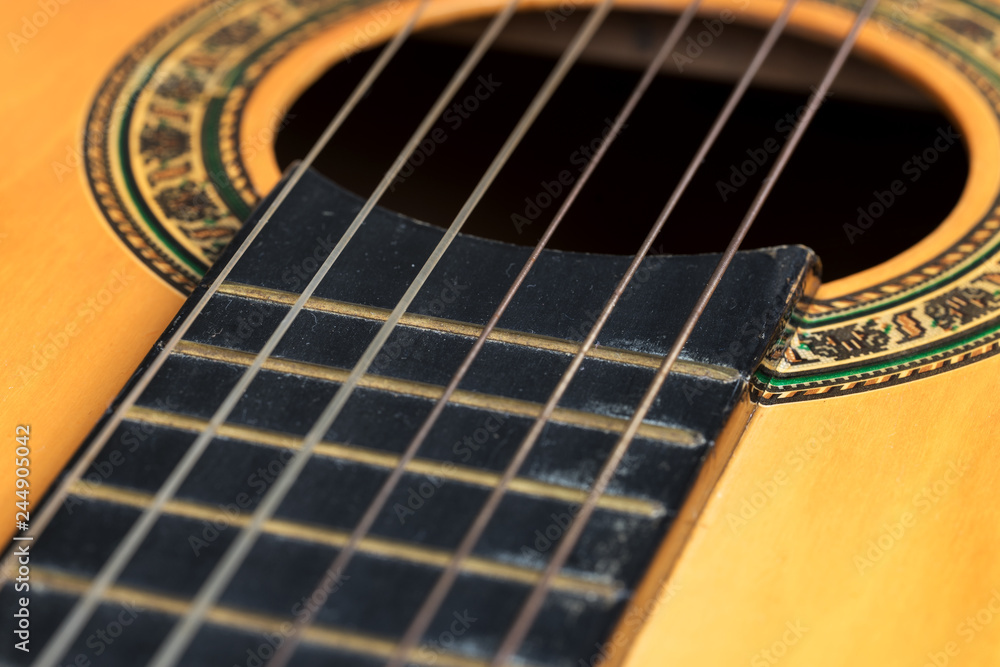Obraz premium Closeup wooden classical guitar. Old classical guitar with nylon strings. Old acoustic guitar