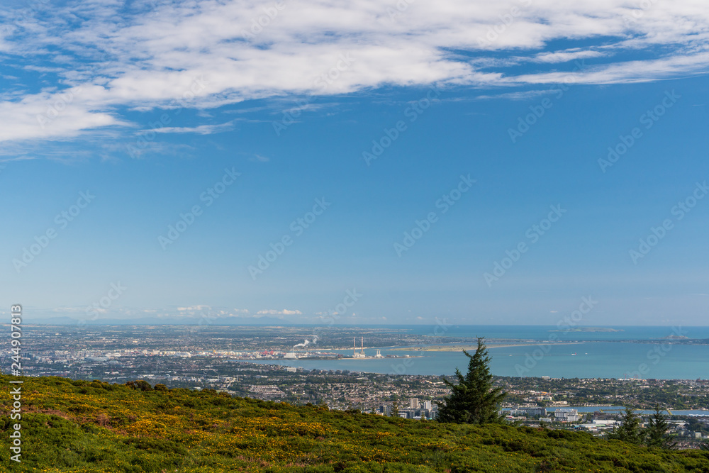 View over Dublin city, Ireland from the Three Rock Mountain peak with the iconic Poolbeg Chimneys in the distance.