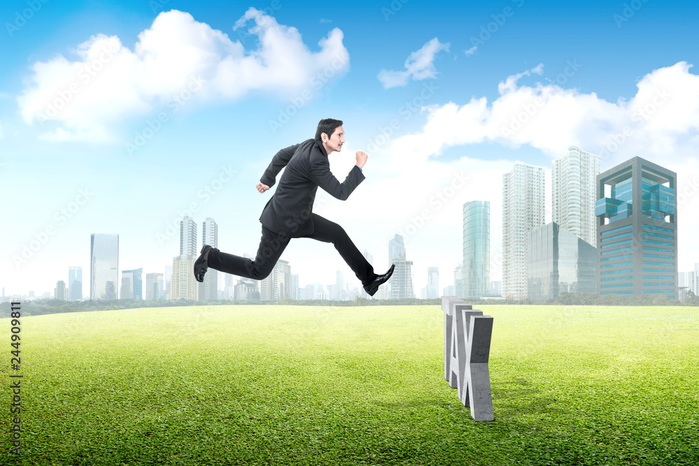 Attractive asian businessman jumping past the taxes Attractive asian businessman jumping past the taxes