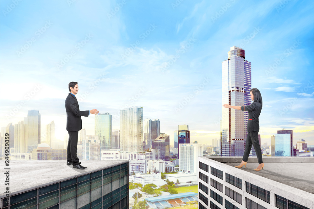 Asian business people standing on different rooftop Asian business people standing on different rooftop