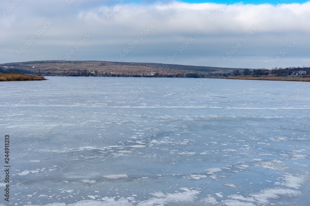 Winter landscape with frozen Karachekrak(left inflow of Dnipro) river in Vasilyvka town, Zaporizhia Oblast, Ukraine.