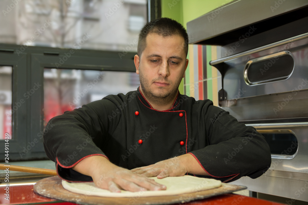 Pizza master preparing dough for pizza with his hands - Image Pizza master preparing dough for pizza with his hands - Image