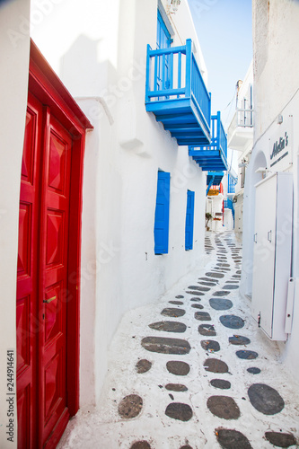 traditional narrow street in Mykonos with blue doors and white walls © Melinda Nagy