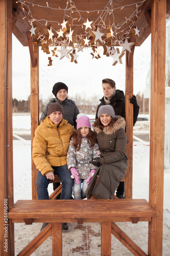 Walk large family in winter ice playground,