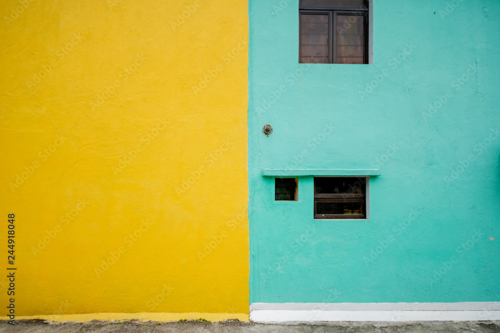 Fototapeta premium Full frame half color of yellow and green on wall in public area window at green side