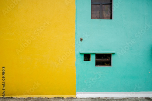 Full frame half color of yellow and green on wall in public area window at green side