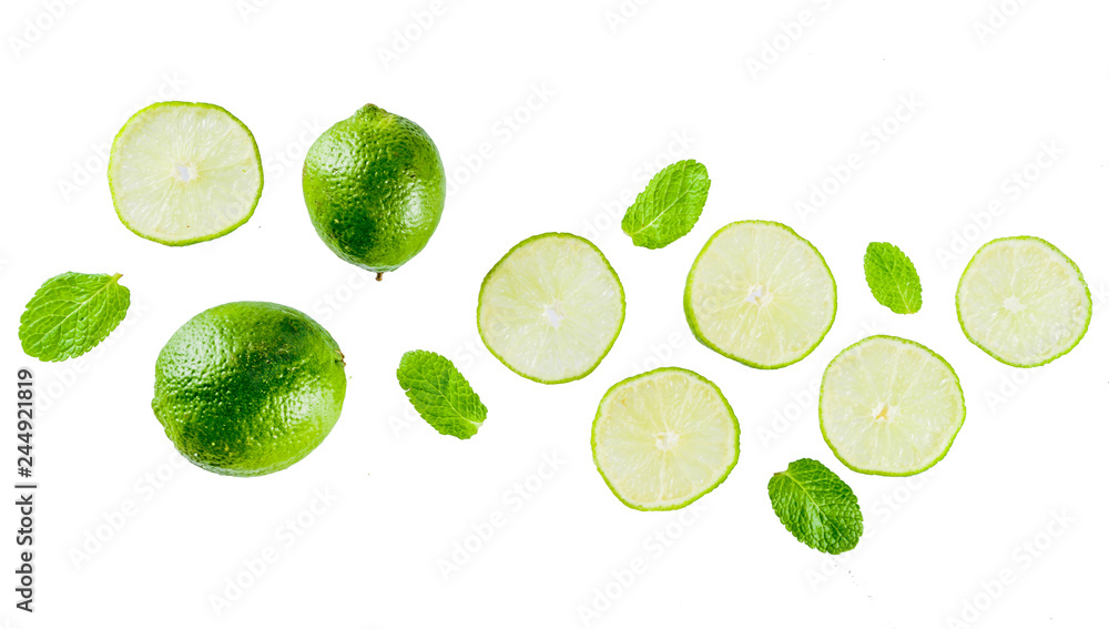 Fresh lime slice with mint leaves isolated on white background, top view copy space. Summer refreshment cocktail ingredient concept. Fresh lime slice with mint leaves isolated on white background, top view copy space. Summer refreshment cocktail ingredient concept.
