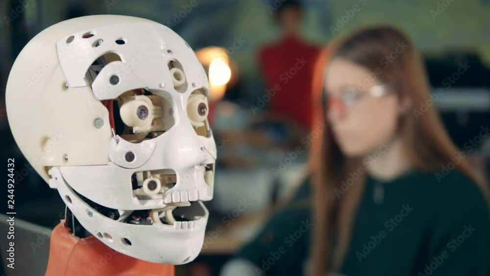 Robotic head opens its mouth under supervision of a female expert Robotic head opens its mouth under supervision of a female expert