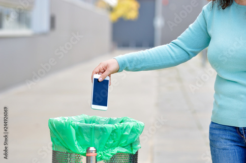 throwing a broken phone in the paper bin