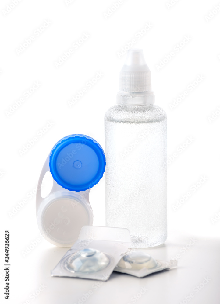 Contact lenses and bottles of fluid on white Contact lenses and bottles of fluid on white