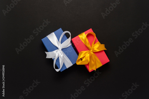 Two gift boxes on a black background. Holiday concept, New Year, Christmas, Birthday, Valentine's Day. Copy space. Flat lay, top view.
