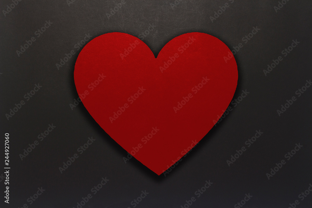 Heart of red cardboard on a black background. Copy space. Flat lay, top view. Heart of red cardboard on a black background. Copy space. Flat lay, top view.
