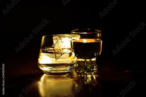 beautiful glasses in the flame of a candle © Oleksii Pyrogov