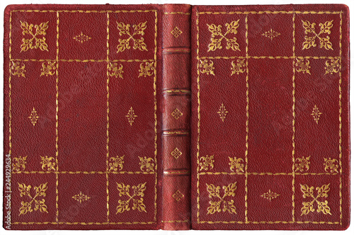 Antique open book in textured red leather cover with floral and abstract embossed golden decorations, isolated on white