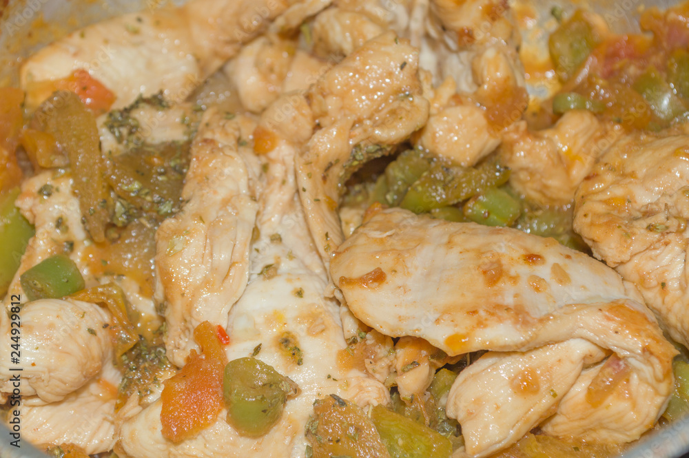 cooked chicken breast in pan, with seasoning spice, sauce, tomatoes and peppers cooked chicken breast in pan, with seasoning spice, sauce, tomatoes and peppers