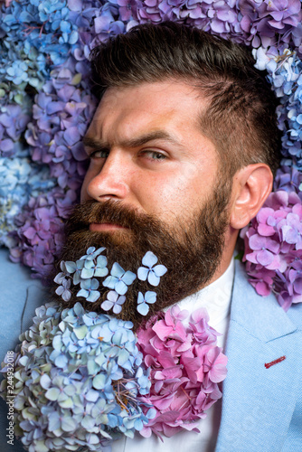 Mature hipster with beard. Healthy hair and skin. male with hydrangea flowers. spring. womens day. brutal caucasian hipster with moustache. Bearded man. Summer. In his own style photo