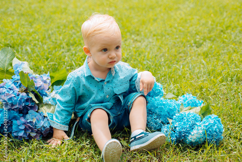 Spring flowers. Childhood. Little boy at blooming flower. Summer. Mothers or womens day. Childrens day. Small baby boy. New life concept. Spring holiday. Come with me photo