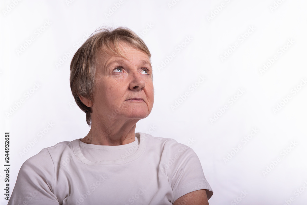 High key portrait of mature female looking up towards the sky High key portrait of mature female looking up towards the sky