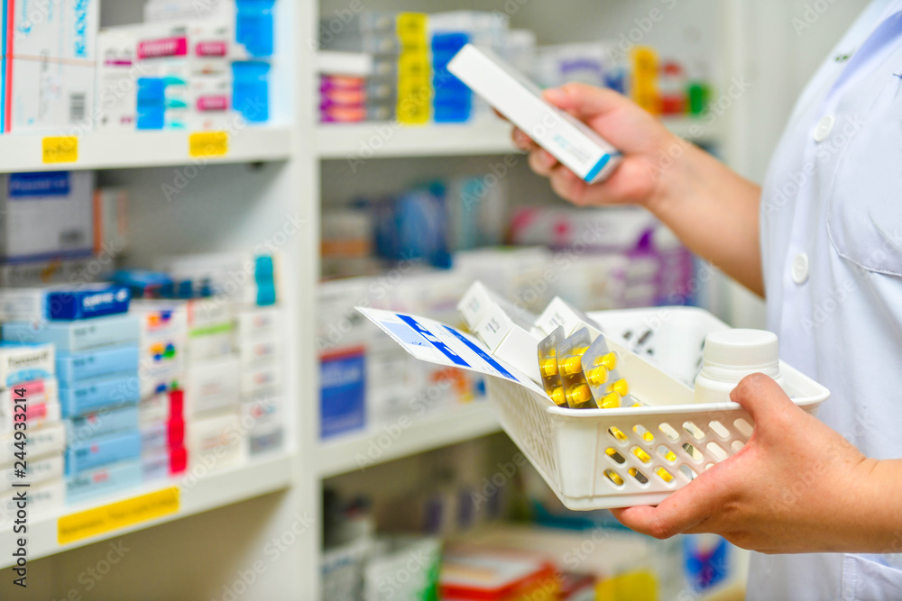 Pharmacist filling prescription in pharmacy drugstore Stock Photo