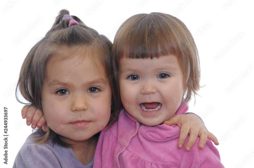 Two little girl hugging portrait isolated on white background. happy siblings different age childhood together Two little girl hugging portrait isolated on white background. happy siblings different age childhood together
