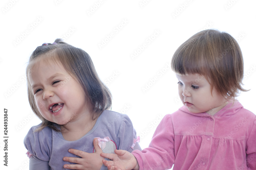 Happy smiling two little girls isolated on white background. sibling with different age emotional communication Happy smiling two little girls isolated on white background. sibling with different age emotional communication