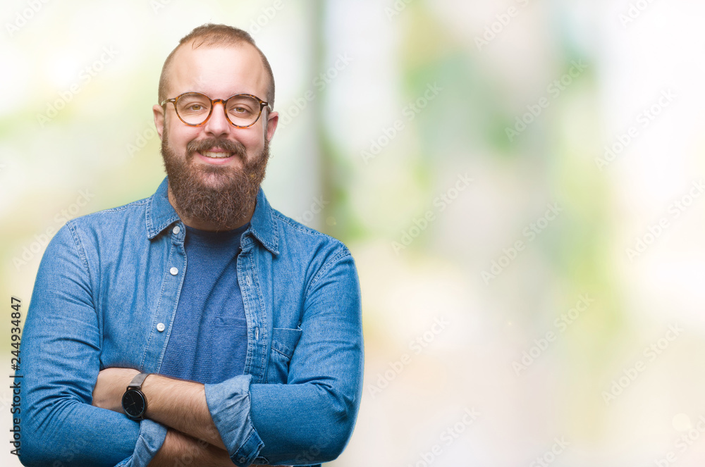 Young caucasian hipster man wearing glasses over isolated background happy face smiling with crossed arms looking at the camera. Positive person. Young caucasian hipster man wearing glasses over isolated background happy face smiling with crossed arms looking at the camera. Positive person.