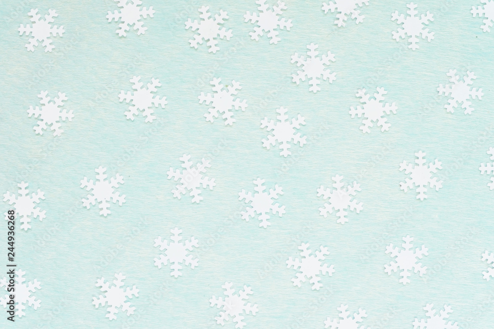 White snowflakes over a turquoise background