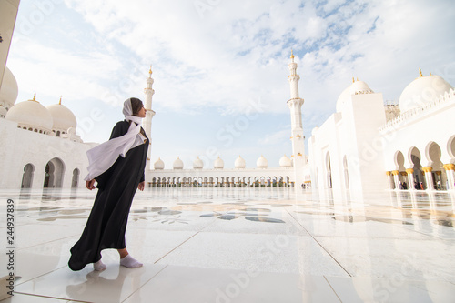 Photography Traditionally dressed arabic woman wearing black burka visiting Sheikh Zayed Grand Mosque in Abu Dhabi, United Arab Emirates