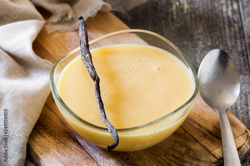 Fotografia, Obraz Bowl of homemade vanilla custard on wooden table