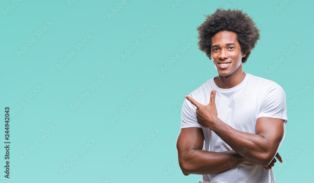 Afro american man over isolated background cheerful with a smile of face pointing with hand and finger up to the side with happy and natural expression on face looking at the camera. Afro american man over isolated background cheerful with a smile of face pointing with hand and finger up to the side with happy and natural expression on face looking at the camera.