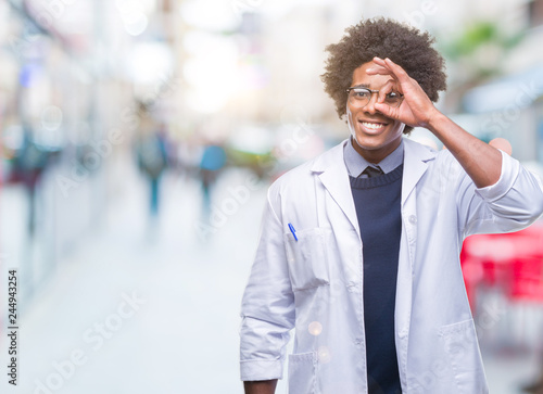 Afro american doctor scientist man over isolated background doing ok gesture with hand smiling, eye looking through fingers with happy face.