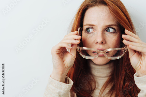 Photography Attractive woman removing her glasses