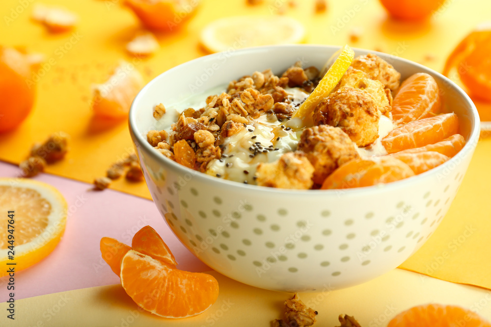 Tasty granola with yogurt and fruits in bowl on color background Tasty granola with yogurt and fruits in bowl on color background