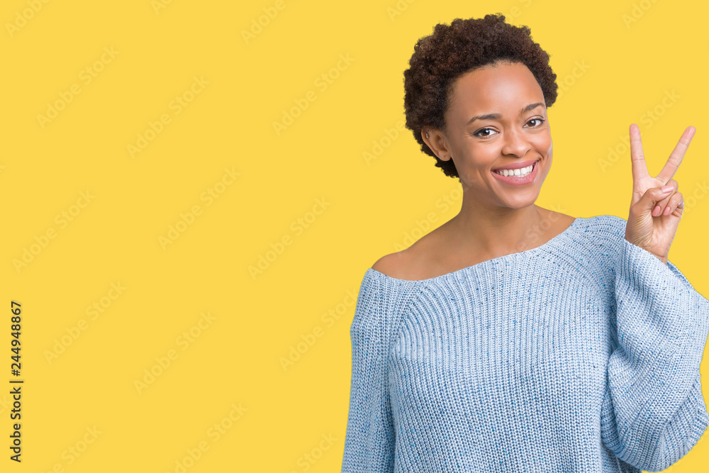 Young beautiful african american woman wearing a sweater over isolated background showing and pointing up with fingers number two while smiling confident and happy. Young beautiful african american woman wearing a sweater over isolated background showing and pointing up with fingers number two while smiling confident and happy.