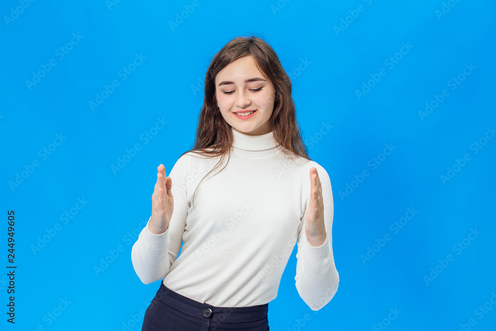 Fototapeta premium Young beautiful girl isolated on blue background