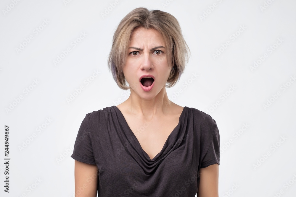 Indignant woman frowns face in displeasure doesnt like something Indignant woman frowns face in displeasure doesnt like something