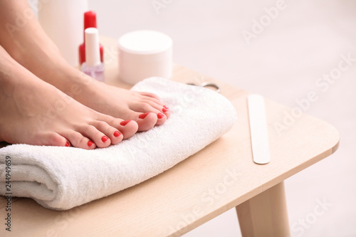 Legs of young woman with beautiful pedicure in beauty salon