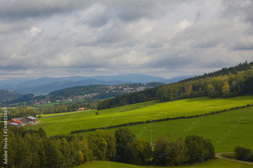 View over hills in the Bavarian forest with cloudy sky