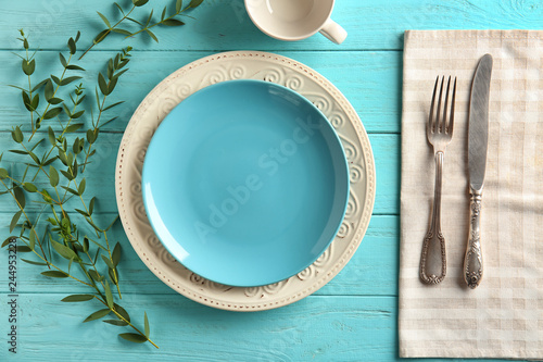 Beautiful table setting with floral decor on wooden background