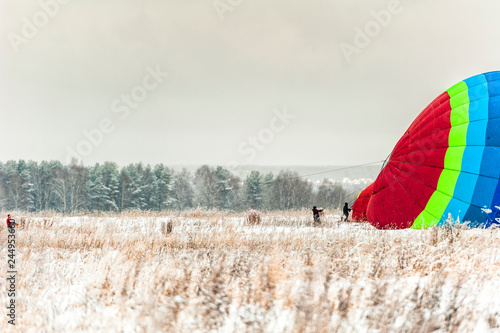 Hot air balloon in the snow in the winter before the start