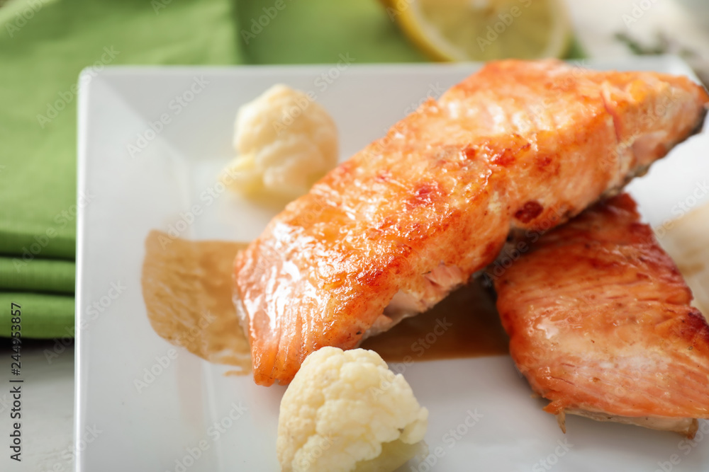 Pieces of tasty grilled salmon on plate, closeup Pieces of tasty grilled salmon on plate, closeup