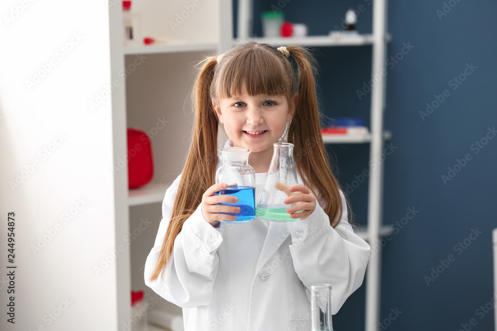 Cute little girl dressed as laboratory worker playing at home Cute little girl dressed as laboratory worker playing at home