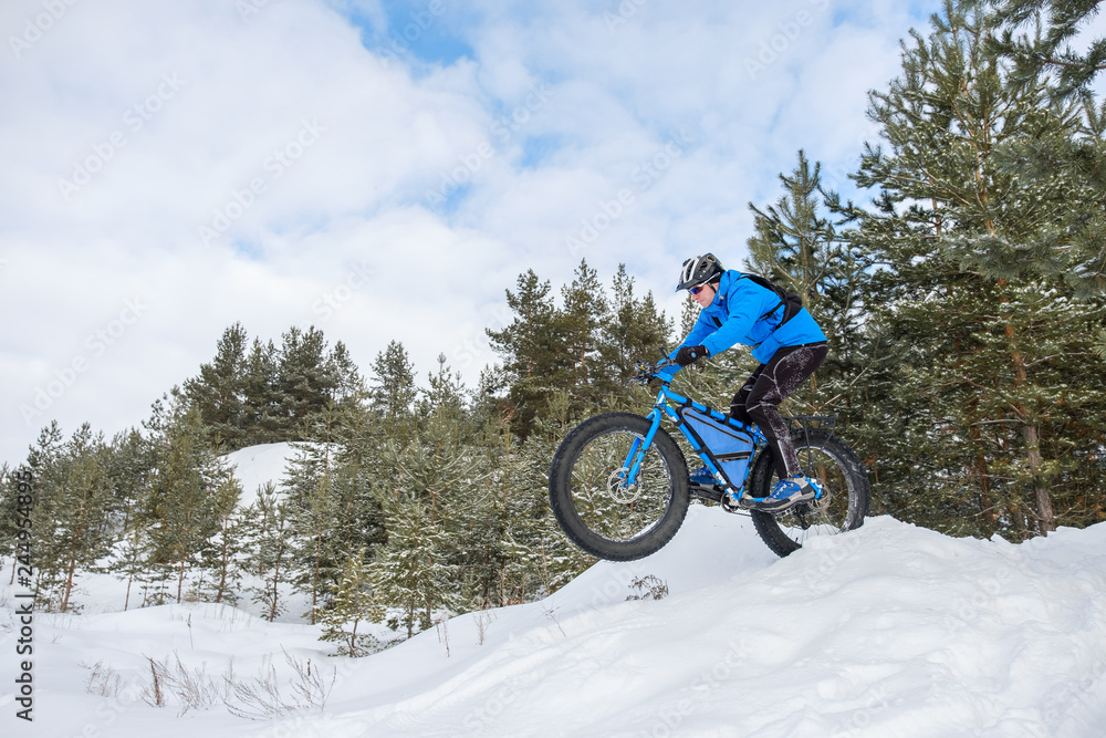 A young man riding fat bicycle in the winter A young man riding fat bicycle in the winter