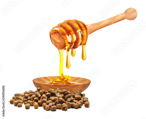 propolis granules and honey dripping isolated on a white background