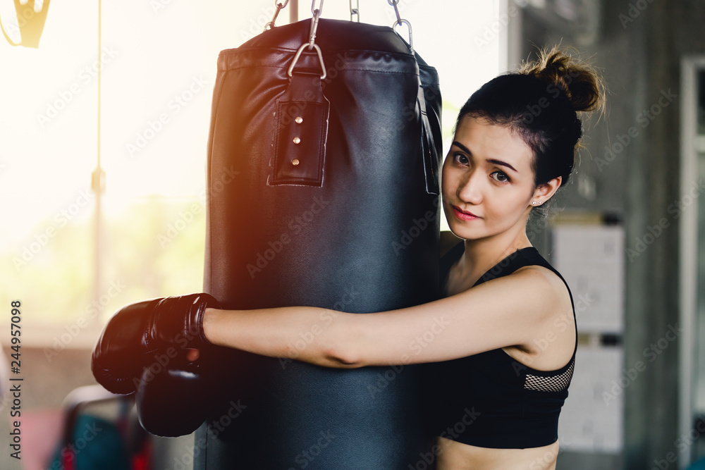 Portrait sporty girl beautiful woman with the back boxing gloves training at the gym