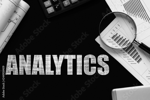 Text Analytics  on chalkboard with graphs, tables, calculations, calculator