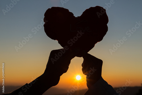 Heart in hands  loving couple and  sunrise background  Couple in love  Happy couple in love   Love couple.